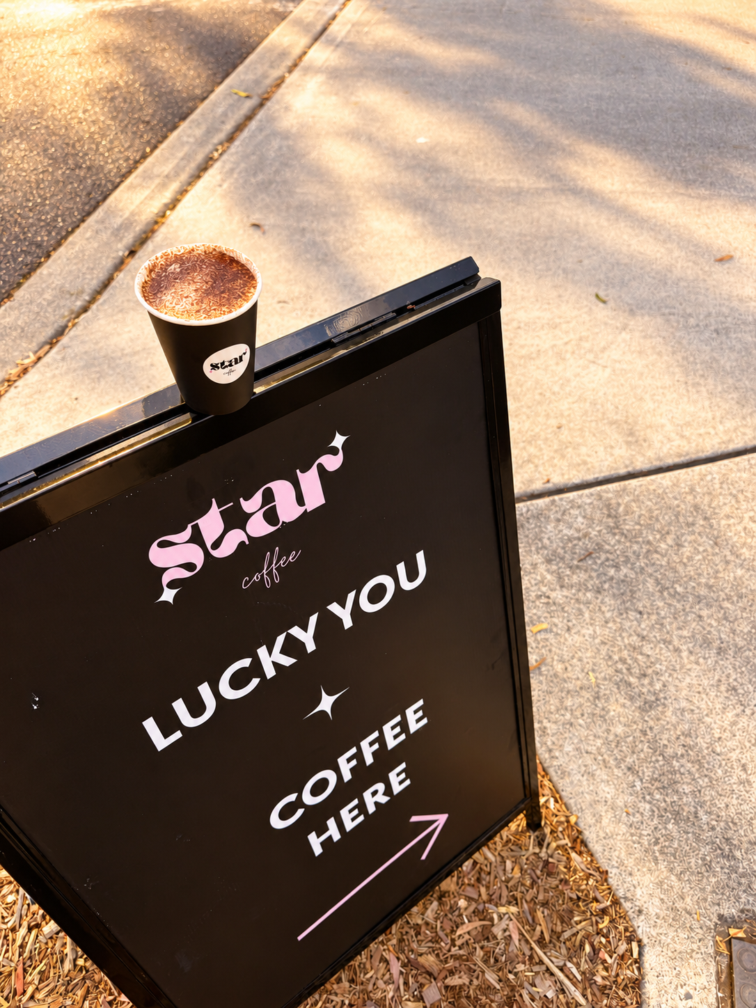 Star Coffee cup on the branded coffee sign